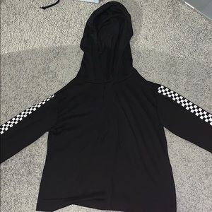 Black crop top hoodie with checkered sleeves.
